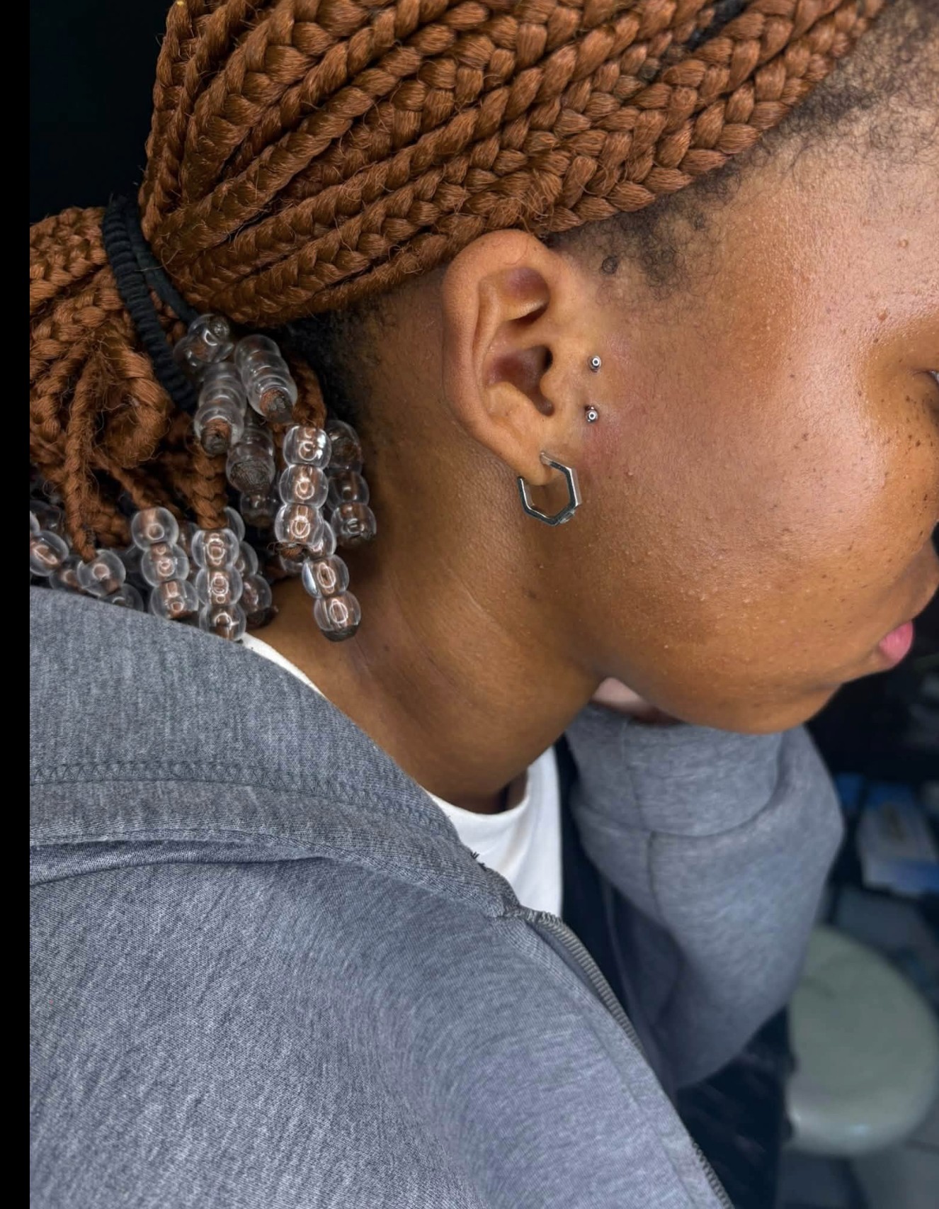 Double inner-conch ear piercing with hexagon hoop — by Professional Black Ink, Rustenburg